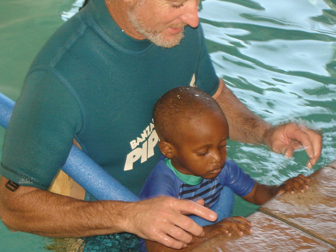 Edward in the pool with a Shark Pup student